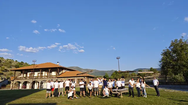 The team in front of a mountain lodge