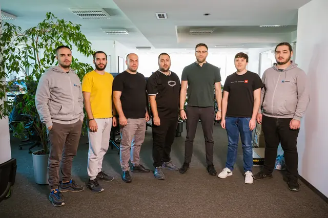 Eight eFellows engineers standing together in the office